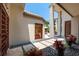 Elegant courtyard entry with stone pathway, tropical plants, and custom wood doors at 601 Weston Pointe Ct, Longboat Key, FL 34228