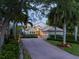 Two-story house with brick driveway, lush landscaping, and a three-car garage at 601 Weston Pointe Ct, Longboat Key, FL 34228