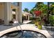 Relaxing hot tub surrounded by tropical landscaping and stone pathway at 601 Weston Pointe Ct, Longboat Key, FL 34228