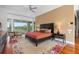 Main bedroom with golf course views and hardwood floors at 601 Weston Pointe Ct, Longboat Key, FL 34228