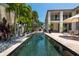 Resort-style pool with spacious patio, lush landscaping, and outdoor seating at 601 Weston Pointe Ct, Longboat Key, FL 34228