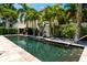 Resort-style pool with lush landscaping and a tranquil water feature at 601 Weston Pointe Ct, Longboat Key, FL 34228