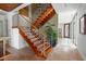 Modern wooden staircase with stainless steel railing at 601 Weston Pointe Ct, Longboat Key, FL 34228