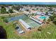 Overhead view of the community amenities featuring a pool, shuffleboard, and tennis and bocce ball courts at 603 Chestnut Ln # 90, Englewood, FL 34223