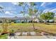 The backyard features a well-maintained lawn and a view of the adjacent home at 603 Chestnut Ln # 90, Englewood, FL 34223