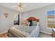 Bright bedroom features a comfortable bed, a ceiling fan, and large windows at 603 Chestnut Ln # 90, Englewood, FL 34223