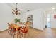 Warm dining room featuring a wooden table, chairs and ornate chandelier at 603 Chestnut Ln # 90, Englewood, FL 34223