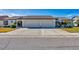 Street view of two single-story homes with attached garages and well-kept lawns at 603 Chestnut Ln # 90, Englewood, FL 34223