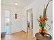 Bright foyer features tiled floors, white door with hearts and doorway to other rooms at 603 Chestnut Ln # 90, Englewood, FL 34223