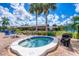 Outdoor hot tub, sun loungers, and tropical landscaping for relaxation at 603 Chestnut Ln # 90, Englewood, FL 34223