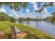 Picturesque lake view with a bench to sit and enjoy the scenic beauty and nature's tranquility at 603 Chestnut Ln # 90, Englewood, FL 34223