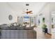 Bright living room with tile flooring, ceiling fan, large sectional, and beach view from the windows at 603 Chestnut Ln # 90, Englewood, FL 34223