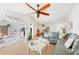 Bright living room with tile flooring, ceiling fan, large sectional, and view to kitchen and dining room at 603 Chestnut Ln # 90, Englewood, FL 34223