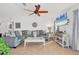 Bright living room with tile flooring, ceiling fan, large sectional, and beach view from the windows at 603 Chestnut Ln # 90, Englewood, FL 34223