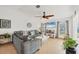 Bright living room with tile flooring, ceiling fan, large sectional, and beach view from the windows at 603 Chestnut Ln # 90, Englewood, FL 34223