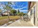 Enjoy outdoor dining on the patio, complete with a table, chairs, and a grill, surrounded by lush landscaping at 603 Chestnut Ln # 90, Englewood, FL 34223