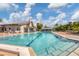 Community pool with lounge seating, manicured landscaping, and inviting clear blue water at 603 Chestnut Ln # 90, Englewood, FL 34223