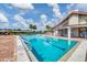 Inviting swimming pool with sun loungers, tables and chairs, and manicured landscaping at 603 Chestnut Ln # 90, Englewood, FL 34223