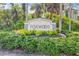 Entrance sign for the Foxwood Community surrounded by lush greenery and tropical plants at 603 Chestnut Ln # 90, Englewood, FL 34223