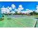 Well-kept tennis court in a lush community with manicured landscaping and a covered picnic area at 603 Chestnut Ln # 90, Englewood, FL 34223