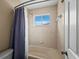 Clean bathroom with shower/tub combo and window at 6150 42Nd Street E Cir, Bradenton, FL 34203