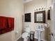 Clean and updated bathroom with pedestal sink and toilet at 6150 42Nd Street E Cir, Bradenton, FL 34203