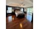 Spacious main bedroom with hardwood floors and sliding doors to balcony at 6150 42Nd Street E Cir, Bradenton, FL 34203