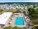 Aerial view of community pool with many people swimming at 62 Pelican S Dr, Oldsmar, FL 34677