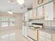 Kitchen area with white cabinets and a window overlooking the outdoors at 62 Pelican S Dr, Oldsmar, FL 34677