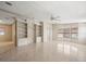 Living room with tile floors, built-in shelving, and window at 62 Pelican S Dr, Oldsmar, FL 34677