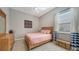 Light and airy bedroom with a pink comforter at 7087 Tamworth Pkwy, Sarasota, FL 34241