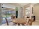 Casual breakfast nook with a round table and chairs overlooking the pool at 7087 Tamworth Pkwy, Sarasota, FL 34241