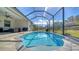 Relaxing kidney-shaped pool with screened enclosure at 7087 Tamworth Pkwy, Sarasota, FL 34241