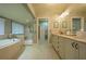 Elegant bathroom with double vanity, soaking tub, and walk-in shower at 716 Tropical Cir, Sarasota, FL 34242