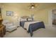 Spacious bedroom with plush bed and access to a private bathroom at 716 Tropical Cir, Sarasota, FL 34242