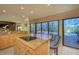 Island kitchen with granite countertops and breakfast bar overlooking the pool at 716 Tropical Cir, Sarasota, FL 34242