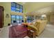 Bright living room with vaulted ceilings, neutral color palette, and access to pool views at 716 Tropical Cir, Sarasota, FL 34242