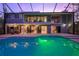 Expansive pool and spa with a screened enclosure, view of house at 716 Tropical Cir, Sarasota, FL 34242