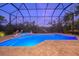 Inviting pool and spa with screened enclosure at 716 Tropical Cir, Sarasota, FL 34242