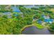 Community overview showing tennis courts, clubhouse, and lake at 7349 Windemere Ln, University Park, FL 34201