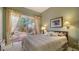 Bright bedroom with sliding glass doors leading to a private patio at 7349 Windemere Ln, University Park, FL 34201