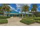 The Varsity Club exterior showcases a teal roof and palm trees at 7349 Windemere Ln, University Park, FL 34201