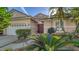 Front view of a charming house with a double door entry and manicured landscaping at 7349 Windemere Ln, University Park, FL 34201