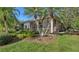 Single-story home with screened patio and lush landscaping at 7349 Windemere Ln, University Park, FL 34201