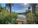 Scenic lake view with a tranquil bench for relaxation at 7349 Windemere Ln, University Park, FL 34201