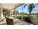 Relaxing screened patio overlooking a serene lake and lush greenery at 7349 Windemere Ln, University Park, FL 34201