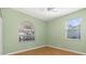 Bedroom with wood flooring, double closet and arched window at 7432 39Th E Ct, Sarasota, FL 34243