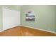 Bedroom with wood flooring, double closet and arched window at 7432 39Th E Ct, Sarasota, FL 34243