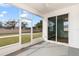 Relaxing screened porch overlooking a grassy backyard at 7432 39Th E Ct, Sarasota, FL 34243