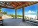 Relaxing view from a covered structure onto a white sand beach and turquoise water at 7808 20Th W Pl, Bradenton, FL 34209